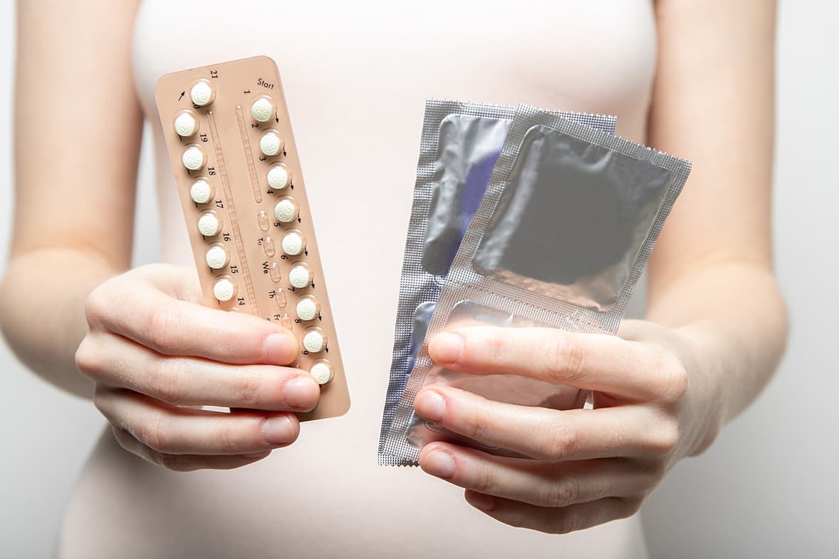 girl holds contraceptive pills condoms her hands contraception