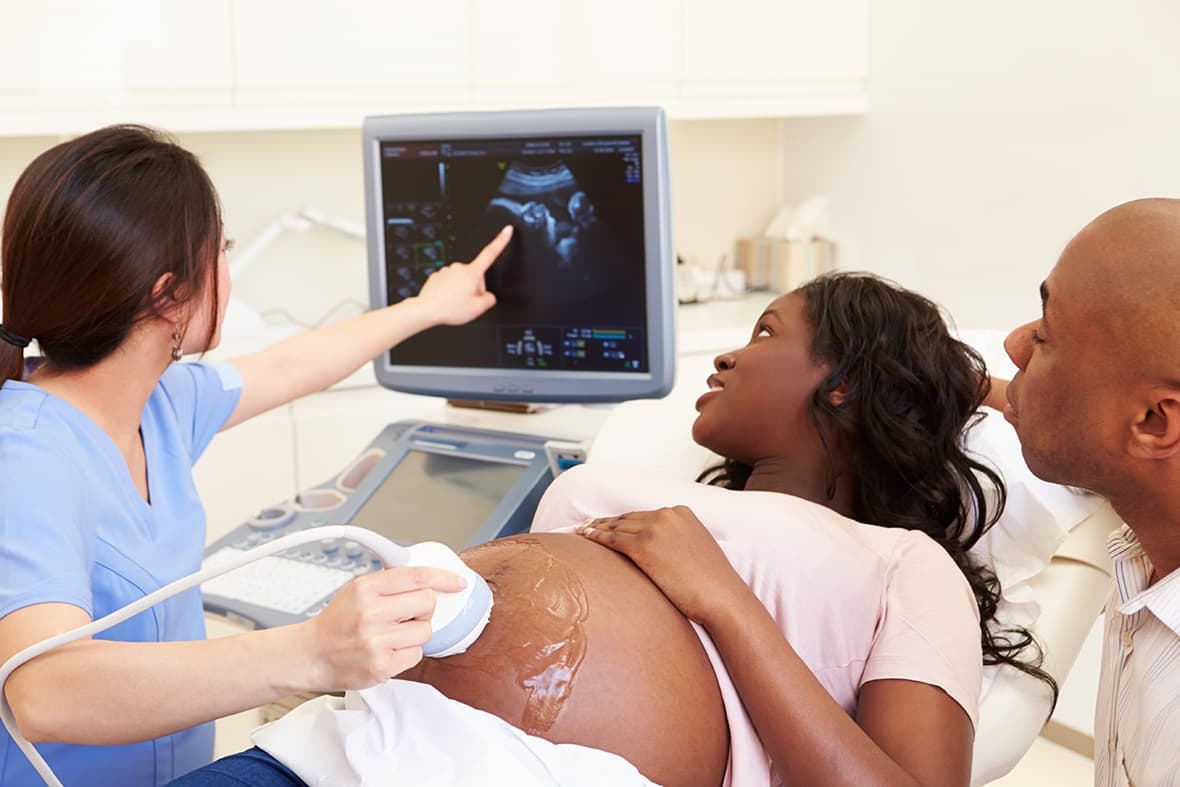 Pregnant woman and partner having 4d ultrasound scan at Rainier OBGYN clinic